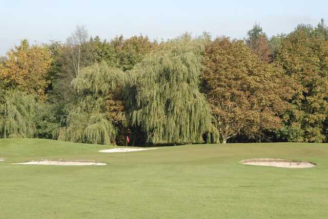 A view of a green guarded by bunkers at Diss Golf Club