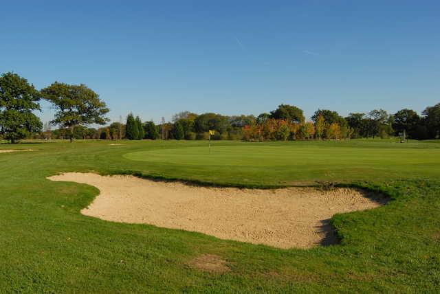 A view of a green protected by sand trap at Horne Park Golf Club