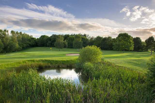 A view of green #11 protected by the pond and sand traps at The Stratford Park Hotel & Golf Club