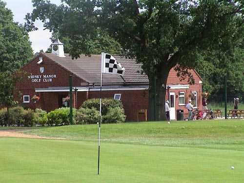 A view of the 18th hole with the clubhouse in background at Widney Manor Golf Club