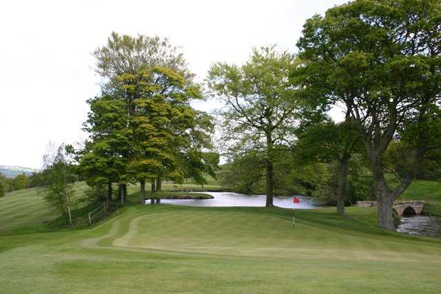 A view of a green with water coming into play at Ben Rhydding Golf Club