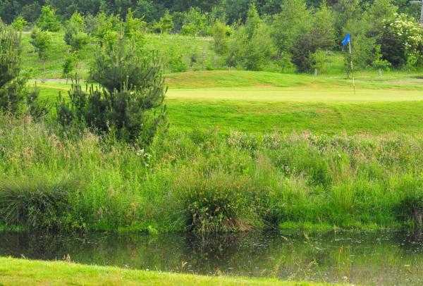 A view over the water of the 2nd hole at Pine Valley Course from Willow Valley Golf
