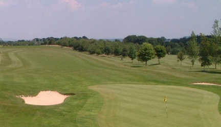A view of a green protected by bunkers at Erlestoke Golf Club