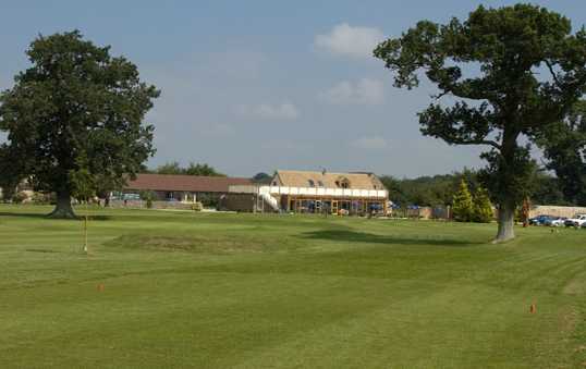A view from a tee with the clubhouse in background at Oaksey Park Golf & Leisure Club.