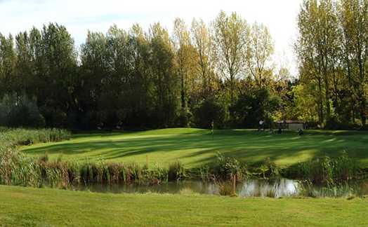 A view of a green with water coming into play at Wrag Barn Golf & Country Club