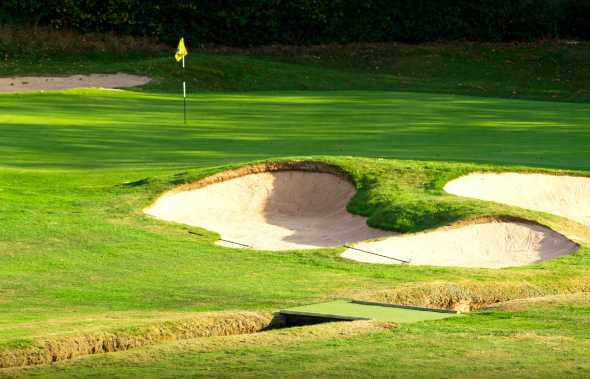 A view of a green guarded by tricky bunkers at Blackwell Golf Club