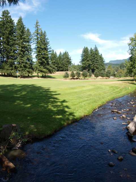 A view of fairway #18 with Boise Creek in the foreground at Enumclaw Golf Course