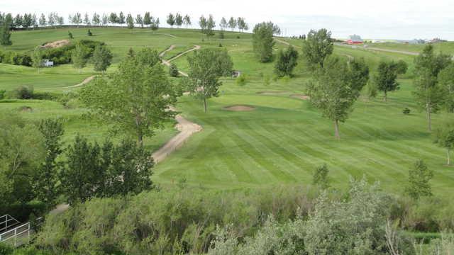 A view of a fairway and a green with narrow path on the left side at Trochu Golf and Country Club