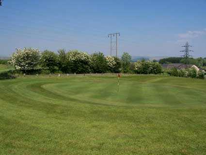 A spring view of a green at Morlais Castle Golf Club