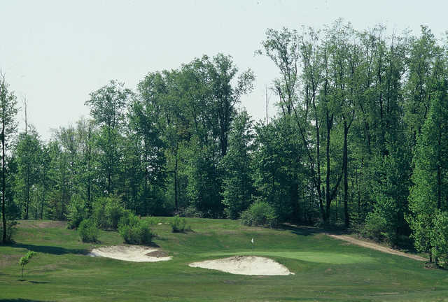 A view of green #1 guarded by tricky bunkers at Cherry Wood Golf Course