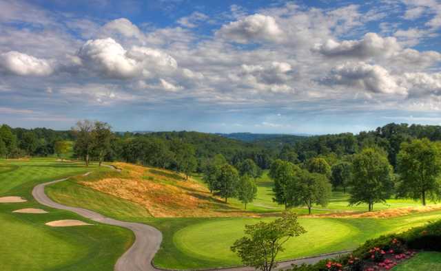 A view of a green with a narrow path on the left side at Edgewood Country Club
