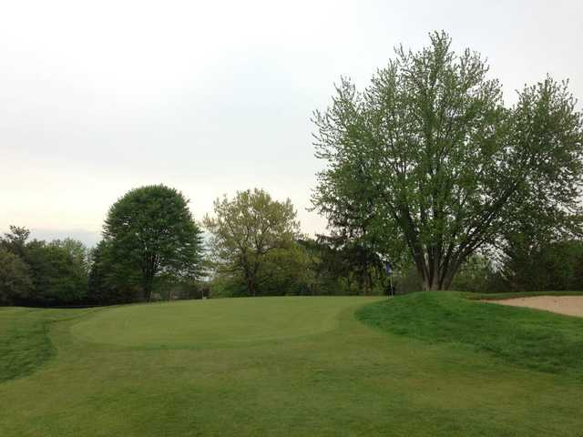 A view of a green protected by a bunker at Georgetown Country Club