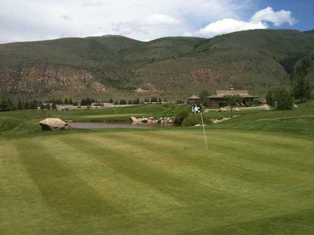 A view of a green protected by a pond at Willow Creek Golf Club from EagleVail.