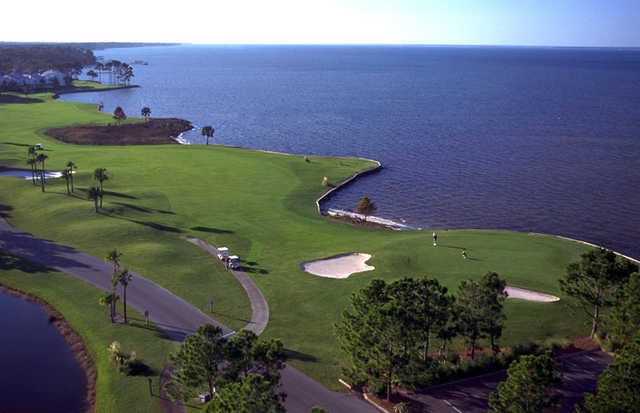 Aerial view of a green and a fairway with water coming into play at Links from Sandestin Resort