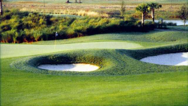 A view of a green protected by bunkers at Stoneybrook West Golf Course