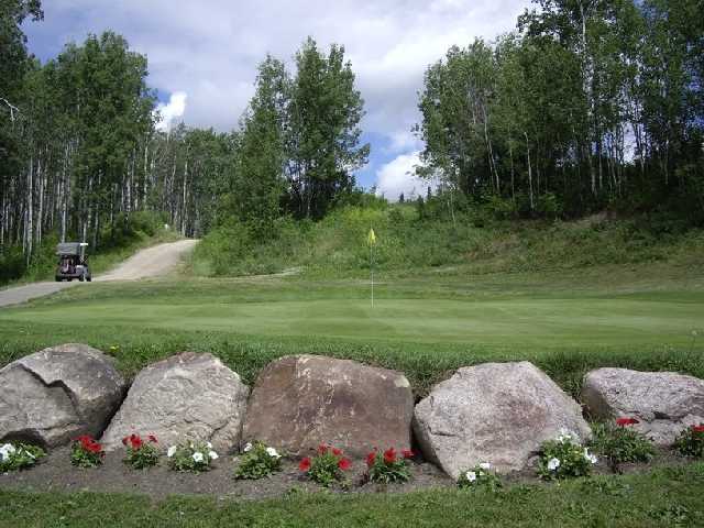 A view of hole #13 with narrow cart path on the left side at Pipestone Golf Club