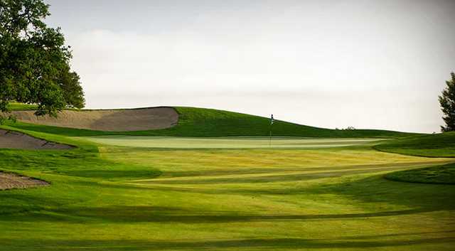 A view of a green protected by sand traps at Hunter Ranch Golf Course