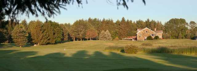 View of the 1st hole and clubhouse at Spring Creek Golf Club