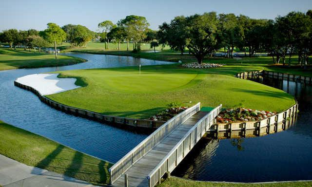 A view of a green surrounded by water at Palm-Aire Country Club
