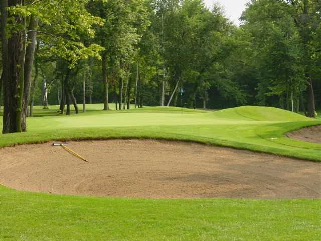 A view of a green protected by tricky sand traps at Blackberry Ridge