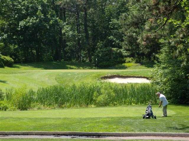 A view of a green protected by a bunker from Ocean County Golf Course at Forge Pond