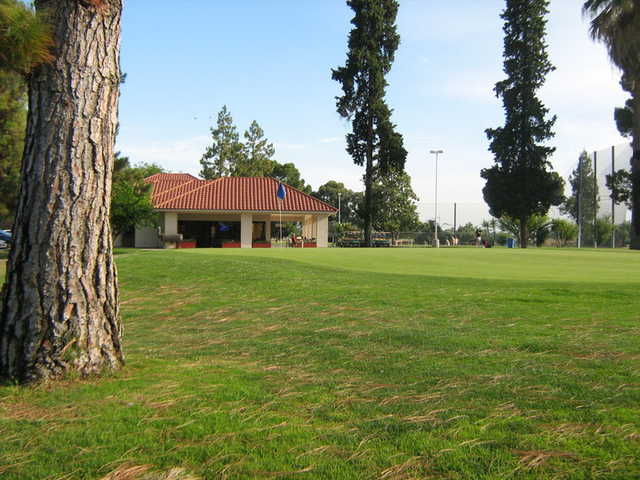 A view of a green and clubhouse at Airways Golf Course