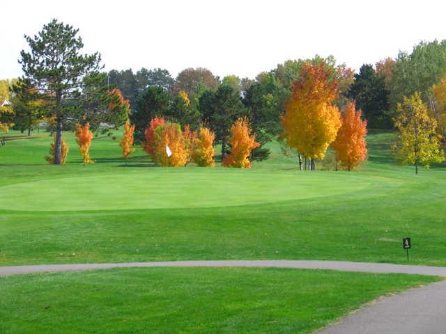 A view of green #4 protected by fall trees at Amery Golf Club
