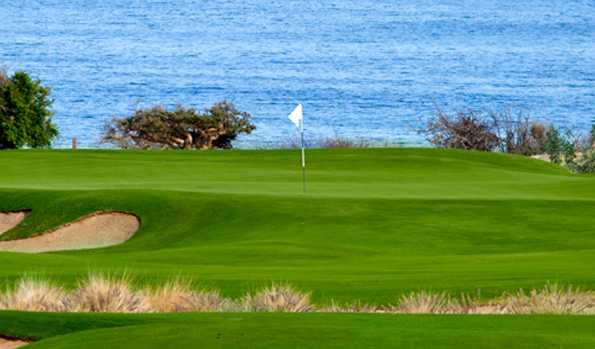 A view of a green with water in background at Club Campestre San Jose