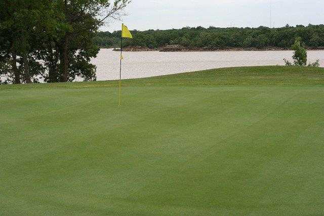 A view of a hole with water in background at Fountainhead Creek Golf Club