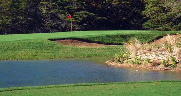 A view of a hole protected by a sand trap from Pines At Clermont