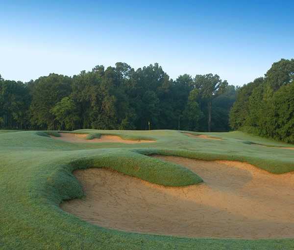 A view of the 17th green protected by bunkers at Black Bear Golf Course