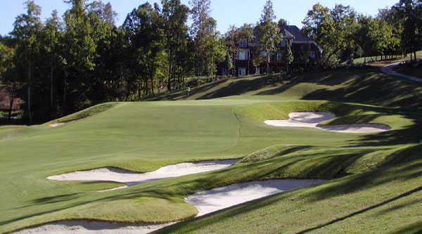 A view of a green protected by a collection of bunkers at Skybrook Golf Club