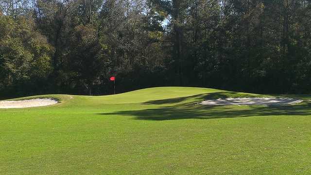 A view of a green protected by tricky bunkers at Holly Hill Golf Club