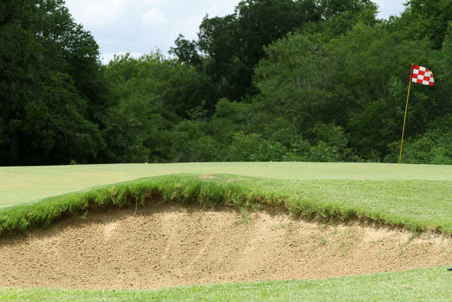 A view of a hole protected by a bunker at Sunset Golf Club.