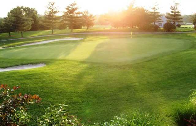 A sunny view of a hole protected by sand traps at Bowling Green Country Club