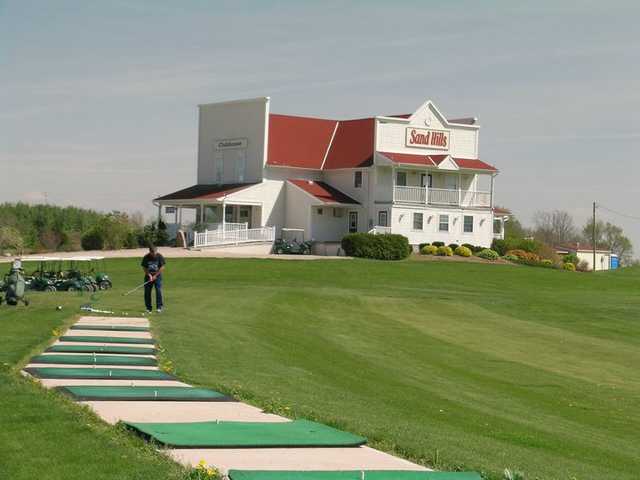 A view of the driving range tees and the clubhouse in the distance at Sand Hills Golf Resort