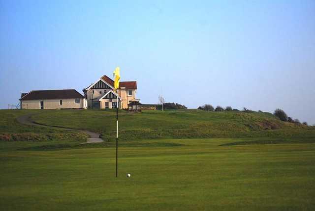 A view of a hole with a narrow path to the clubhouse in background at Ashburnham Golf Club