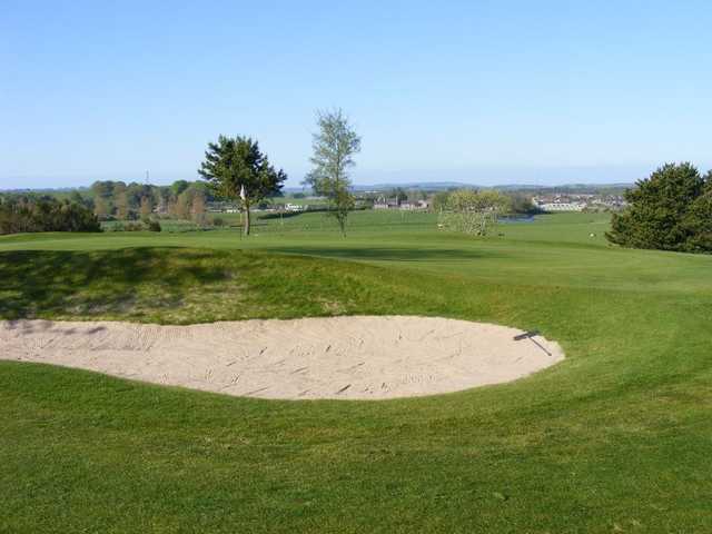 A view of the 1st hole guarded by bunker at Kintore Golf Club