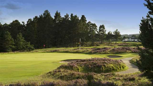 A sunny day view of a hole with a narrow path on the right side at Grantown-on-Spey Golf Club
