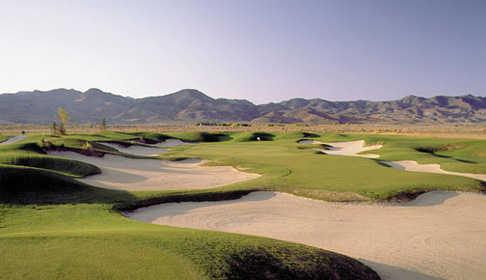 A view of a green surrounded by tricky sand traps from Dayton Valley Golf Club (Arnold Palmer Design)