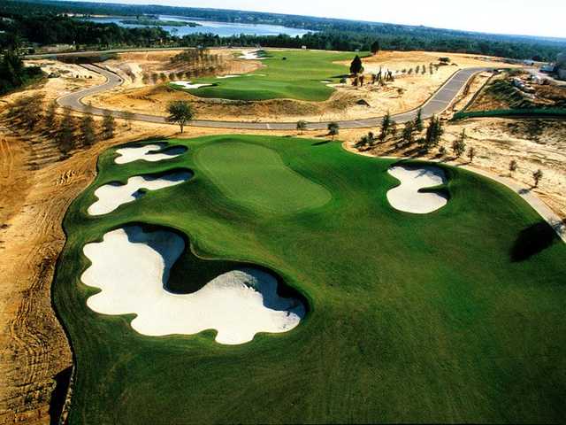 A view of a green surrounded by tricky bunkers at Bella Collina Golf Club