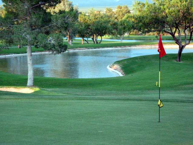 A view of a hole with water in background at Desert Hills Golf Club