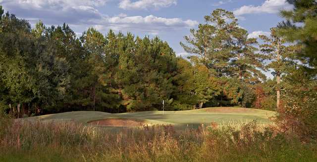 A view of a green protected by bunkers at River Pointe Golf Club