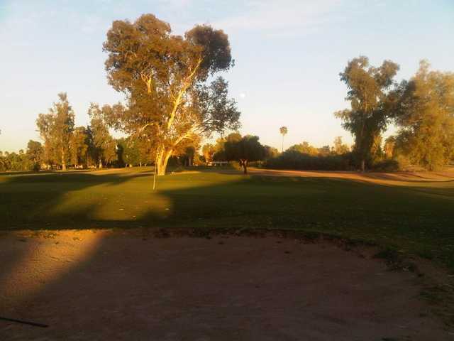 A sunset view of a hole at Shalimar Golf Club