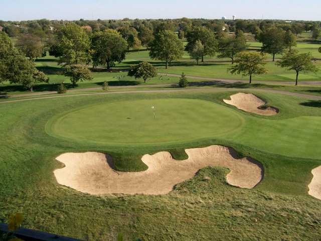 A view of a hole surrounded by undulating bunkers from Woodland at Blackhawk Trace Golf Club at Indian Lakes Resort
