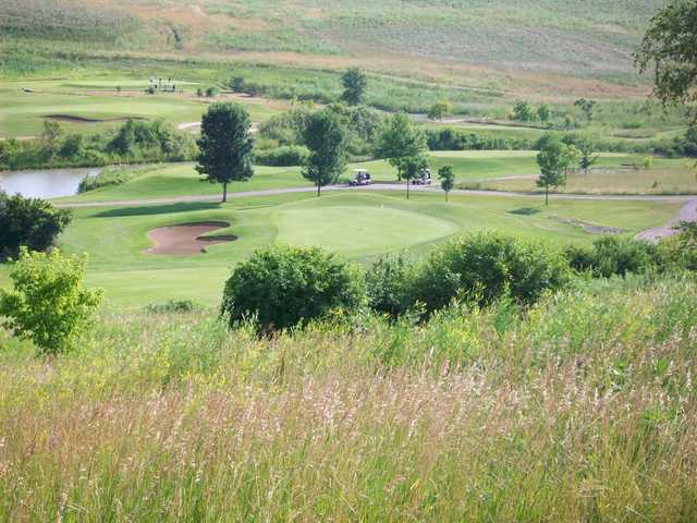 A view of a green protected by a bunker at Settler's Hill Golf Course.