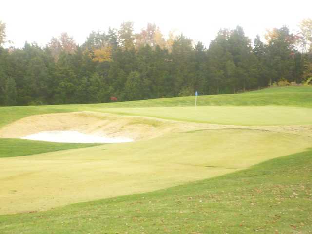 A view of a hole protected by a bunker at Bear Creek Golf Club