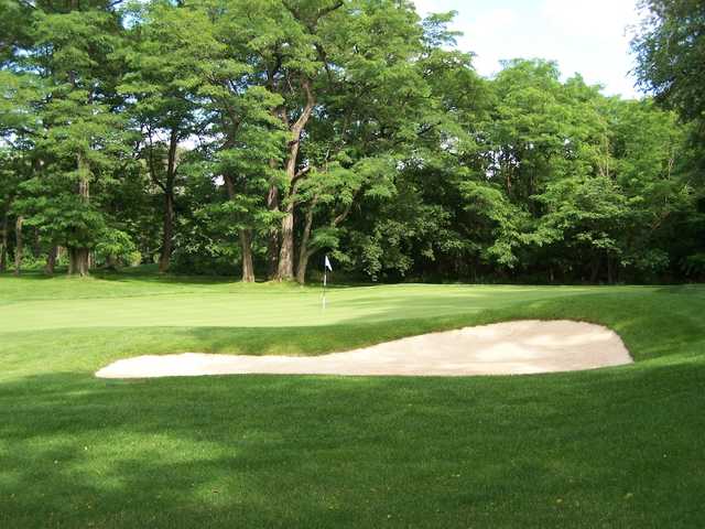 A view of a hole protected by a bunker at Mosholu Golf Course