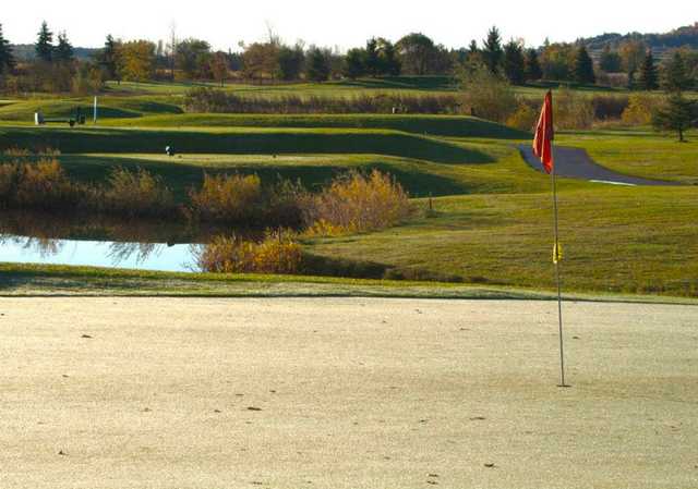 A view of a green with water coming into play at Granite Ridge Golf Club