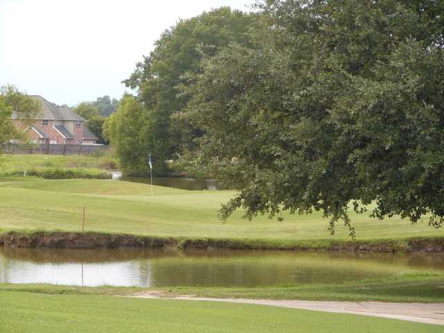 A view over the water of the 9th hole at Belle Terre Country Club